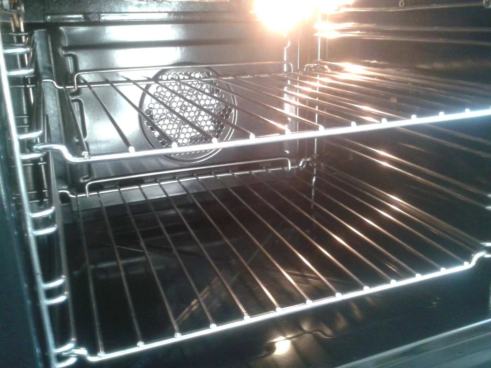 Interior of a single oven with heating element and racks