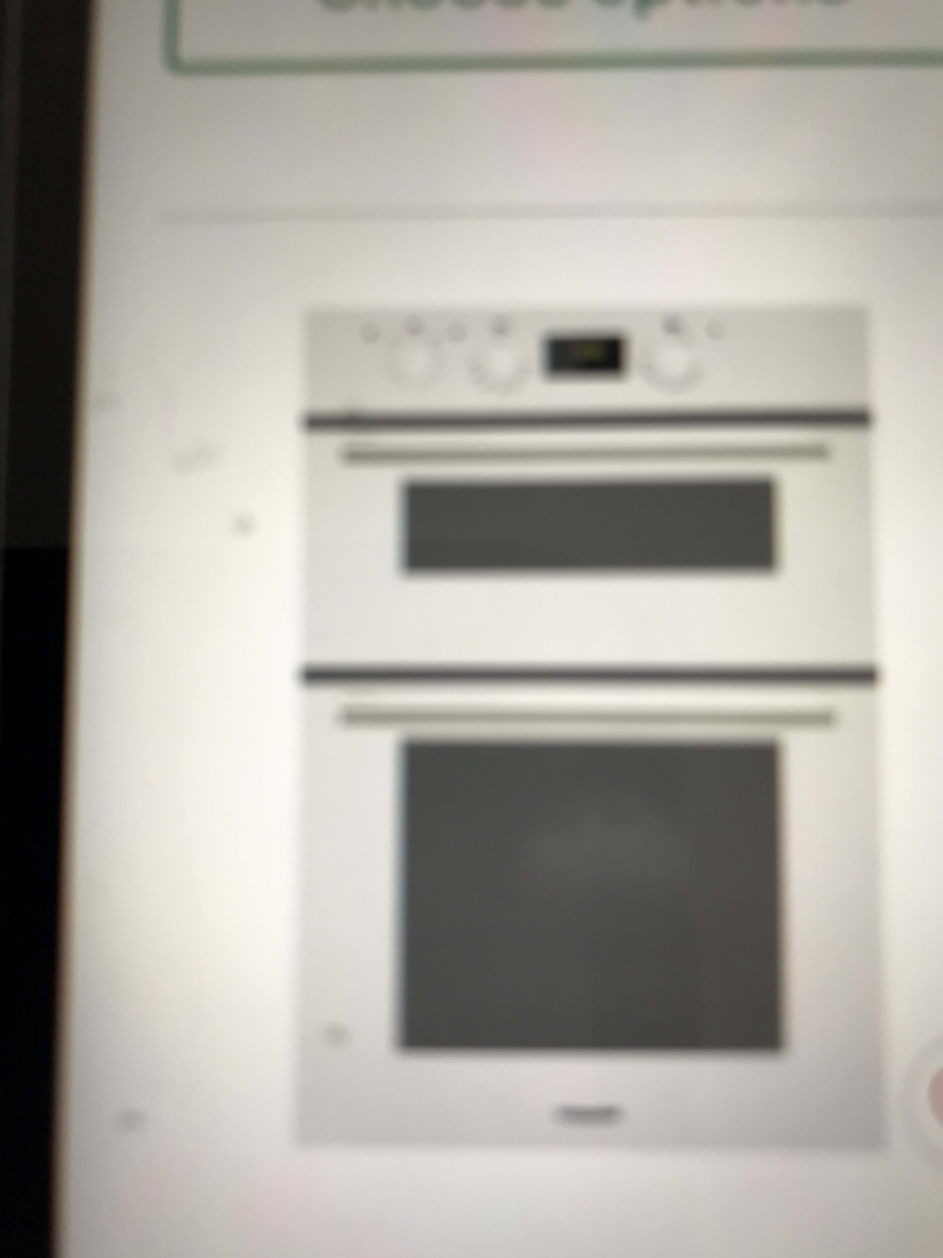 Built-in double oven appliance in a white kitchen cabinet